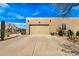 Spacious 2-car garage and driveway of a single story home with desert landscaping at 46827 N 8Th Ave, New River, AZ 85087