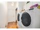 Well-lit laundry room with washer, dryer, and storage cabinets at 46827 N 8Th Ave, New River, AZ 85087