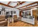 Open-concept living room showcasing hardwood floors, comfortable seating, and seamless transition to the kitchen at 46827 N 8Th Ave, New River, AZ 85087