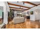 Spacious living room includes wood flooring, a fireplace, a beamed ceiling, and an open floor plan at 46827 N 8Th Ave, New River, AZ 85087