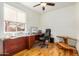 Home office with a wooden desk, rolling chair, and large window overlooking the outside at 46827 N 8Th Ave, New River, AZ 85087