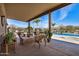 Covered patio featuring a wooden furniture set and a view of the pool at 46827 N 8Th Ave, New River, AZ 85087