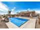 Backyard pool with desert landscaping and covered patio, creating an ideal space for relaxation and entertainment at 46827 N 8Th Ave, New River, AZ 85087