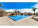 Inviting backyard pool with rock waterfall and desert landscaping creates a tranquil outdoor space at 46827 N 8Th Ave, New River, AZ 85087