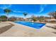 Sparkling pool with rock waterfall feature and desert landscaping, perfect for outdoor entertaining and relaxation at 46827 N 8Th Ave, New River, AZ 85087