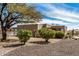 Single-story home with desert landscaping, mature tree, and large gravel area at 46827 N 8Th Ave, New River, AZ 85087