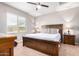 King bedroom with wood platform bed, nightstands, and ceiling fan at 4908 S 244Th Ave, Buckeye, AZ 85326