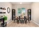 Bright dining room with wood table, four metal chairs, and built-in shelving units at 4908 S 244Th Ave, Buckeye, AZ 85326