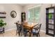 Bright dining room features a wood table with four metal chairs and built-in shelving at 4908 S 244Th Ave, Buckeye, AZ 85326