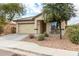 One-story house featuring a beige exterior, two-car garage, and inviting porch at 4908 S 244Th Ave, Buckeye, AZ 85326