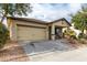 Single-story house, tan exterior, two-car garage, and a covered porch at 4908 S 244Th Ave, Buckeye, AZ 85326