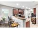 Modern kitchen with granite counters, dark wood cabinets, and stainless steel appliances at 4908 S 244Th Ave, Buckeye, AZ 85326