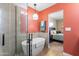 Modern bathroom with freestanding tub, glass shower, and coral walls at 530 E Calavar Rd, Phoenix, AZ 85022