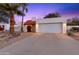 Inviting desert home exterior with a two-car garage and nicely landscaped front yard at 530 E Calavar Rd, Phoenix, AZ 85022