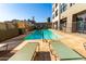 Community pool with lounge chairs and building view at 535 W Thomas Rd # 213, Phoenix, AZ 85013