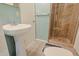 Bathroom with pedestal sink, shower, and tile flooring at 6016 N 36Th Dr, Phoenix, AZ 85019