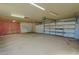 Spacious garage with large door and painted brick wall at 6016 N 36Th Dr, Phoenix, AZ 85019