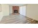 Living room featuring a brick fireplace and wood-look floors at 6016 N 36Th Dr, Phoenix, AZ 85019