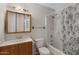 Bathroom with wood vanity, shower/tub combo, and updated fixtures at 6415 S El Camino Dr, Tempe, AZ 85283