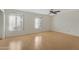 Large bedroom with light laminate flooring and two windows at 6415 S El Camino Dr, Tempe, AZ 85283