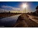 Scenic canal-side walking path at sunset, offering peaceful neighborhood views at 6415 S El Camino Dr, Tempe, AZ 85283