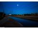 Night view of a canal path with homes in background at 6415 S El Camino Dr, Tempe, AZ 85283