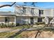 Two-story condo with light-colored siding, a walkway, and landscaping at 6415 S El Camino Dr, Tempe, AZ 85283