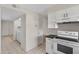 Kitchen with white cabinets, black countertops, and a view of the laundry area at 6415 S El Camino Dr, Tempe, AZ 85283