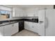 Modern kitchen with white cabinets, black countertops, and stainless steel appliances at 6415 S El Camino Dr, Tempe, AZ 85283