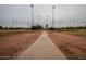 Pathway leading to baseball fields under tall lights at 6415 S El Camino Dr, Tempe, AZ 85283