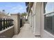 Side view of a townhouse with a gated patio and walkway at 6565 E Thomas Rd # 1141, Scottsdale, AZ 85251