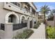 Side view of a modern townhouse with a walkway and landscaping at 6565 E Thomas Rd # 1141, Scottsdale, AZ 85251