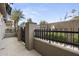 Side view of a townhouse with a gate and paved walkway at 6565 E Thomas Rd # 1141, Scottsdale, AZ 85251