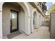 Townhouse entryway with a black door and brick pathway at 6565 E Thomas Rd # 1141, Scottsdale, AZ 85251