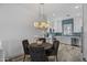 Modern kitchen with white cabinets and a light wood dining table at 6565 E Thomas Rd # 1141, Scottsdale, AZ 85251