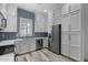 Modern kitchen with stainless steel appliances and blue tile backsplash at 6565 E Thomas Rd # 1141, Scottsdale, AZ 85251