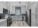 Modern kitchen with stainless steel appliances and blue tile backsplash at 6565 E Thomas Rd # 1141, Scottsdale, AZ 85251