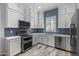 Modern kitchen with stainless steel appliances and blue tile backsplash at 6565 E Thomas Rd # 1141, Scottsdale, AZ 85251