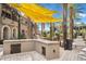 Outdoor kitchen with grills and a large shaded patio area at 6565 E Thomas Rd # 1141, Scottsdale, AZ 85251