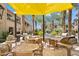 Outdoor seating area with tables and grills under a large shade sail at 6565 E Thomas Rd # 1141, Scottsdale, AZ 85251