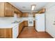 Kitchen with wood cabinets, white appliances, and a white countertop at 6730 W Vernon Ave, Phoenix, AZ 85035