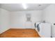 Laundry room with washer, dryer, and wood flooring at 6730 W Vernon Ave, Phoenix, AZ 85035