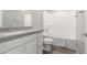 Clean bathroom with a tub, toilet and vanity with grey countertop at 7214 W Buckhorn Trl, Peoria, AZ 85383