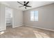 Well-lit bedroom with built-in shelving and ceiling fan at 7214 W Buckhorn Trl, Peoria, AZ 85383