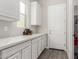 Laundry room with white cabinets and built-in storage at 7214 W Buckhorn Trl, Peoria, AZ 85383