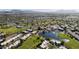 Aerial view of community with golf course, pool, and lake at 7737 E Columbine Way, Mesa, AZ 85208