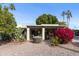 Landscaped backyard with desert plants and a covered patio at 7737 E Columbine Way, Mesa, AZ 85208