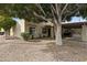 House exterior with a large tree and golf cart parking at 7737 E Columbine Way, Mesa, AZ 85208