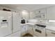 White kitchen with stainless steel appliances and granite countertops at 7737 E Columbine Way, Mesa, AZ 85208