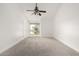 Bright bedroom featuring a ceiling fan and large window at 7910 E Thomas Rd # 118, Scottsdale, AZ 85251